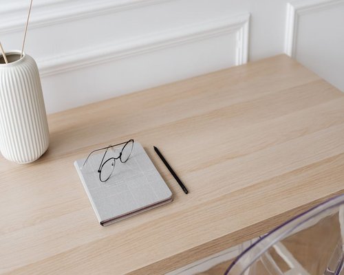 A notebook and pen on a clean office desk in Miraflores