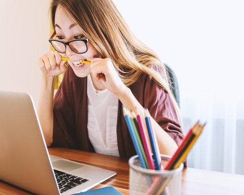 A person stretching gently by their office desk